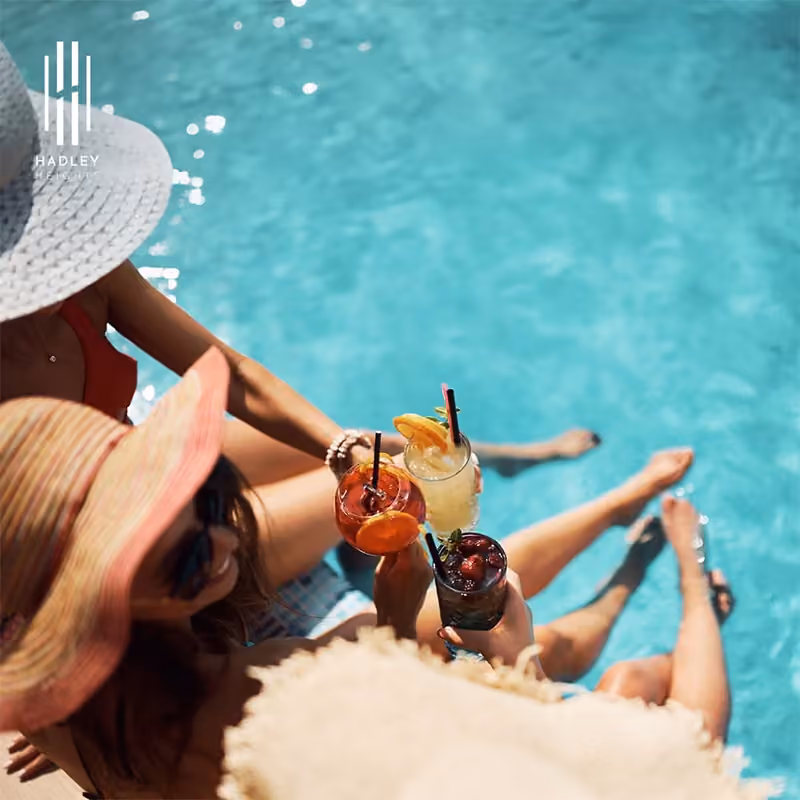 Hadley Heights campaign creative showing poolside leisure beside turquoise water